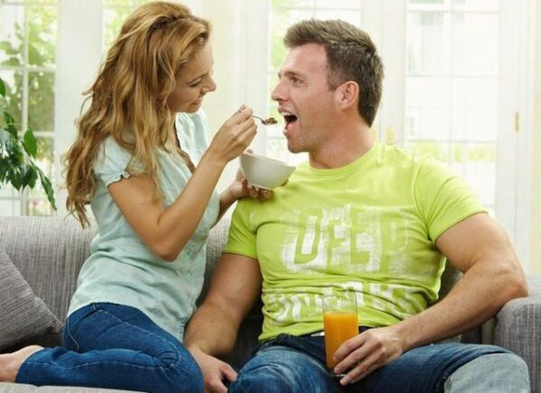 a woman feeds a man with products to increase her potential